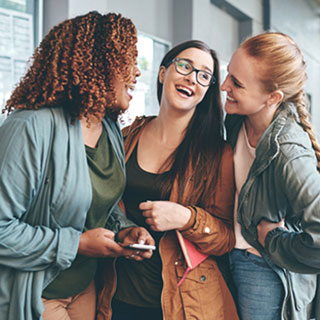 group of three girls laughing together